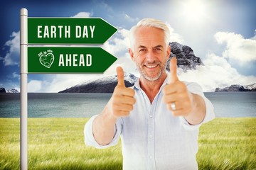 Poster - Composite image of smiling man showing thumbs up to camera