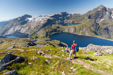 Wall Mural - Man takes rest on top of mountain in Norway