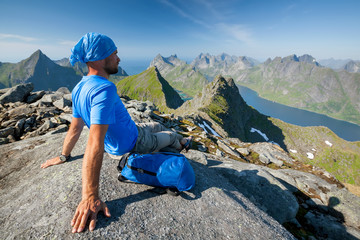 Wall Mural - Man takes rest on top of mountain in Norway