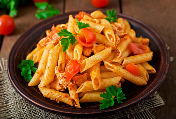 Wall Mural - Penne pasta in tomato sauce with chicken, tomatoes