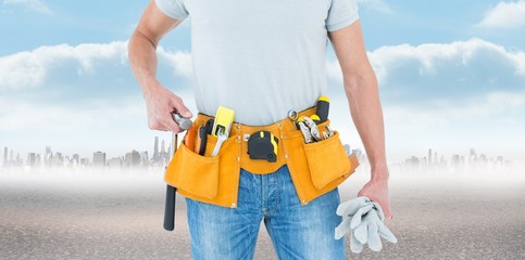 Poster - Composite image of technician holding gloves and hammer