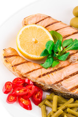 Wall Mural - Grilled salmon steak with vegetables on plate.