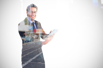 Poster - Businessman looking at the camera while using his tablet