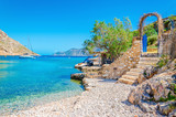 Fototapeta Morze - Stairs from sandy beach on Greece island Kalymnos