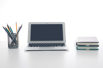 Still-life portrait of computer, pen, coffee mug on table, busin