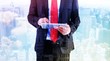 © WavebreakMediaMicro - Composite image of businessman scrolling on his digital tablet