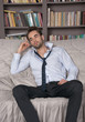 © allai - Young man in a suit lying on the sofa