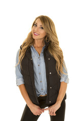 woman with black vest stand tilt head smile