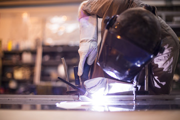 Wall Mural - Employee welding stainless steel using welder machine