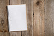 Lined notepad on old wooden background
