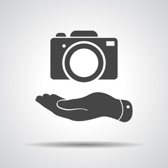 Wall Mural - flat hand shows the photo camera icon - vector illustration