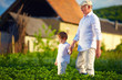 © Olesia Bilkei - grandfather and grandson together on their homestead