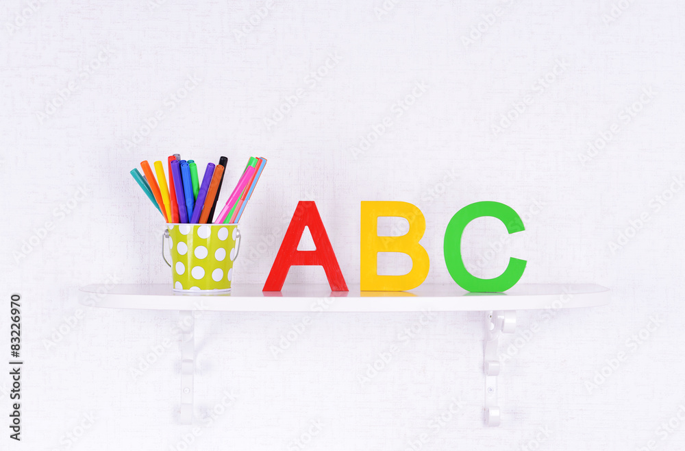 Shelves with stationery in child room close-up