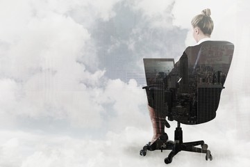 Poster - Businesswoman sitting on swivel chair with laptop