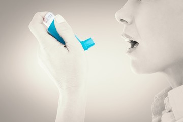 Poster - Composite image of close up of a woman using an asthma inhaler