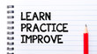 Learn, Practice, Improve, Text written on notebook page