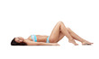© Syda Productions - happy young woman lying in bikini swimsuit