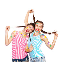 Two lovely painted girl friends having fun