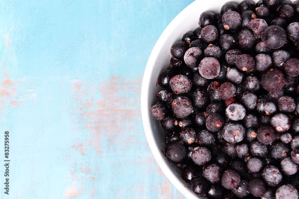 Blackberry in bowl on wooden background