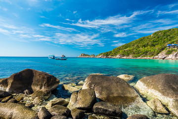 Rock beach and blue sky with beautiful clouds tropical sea