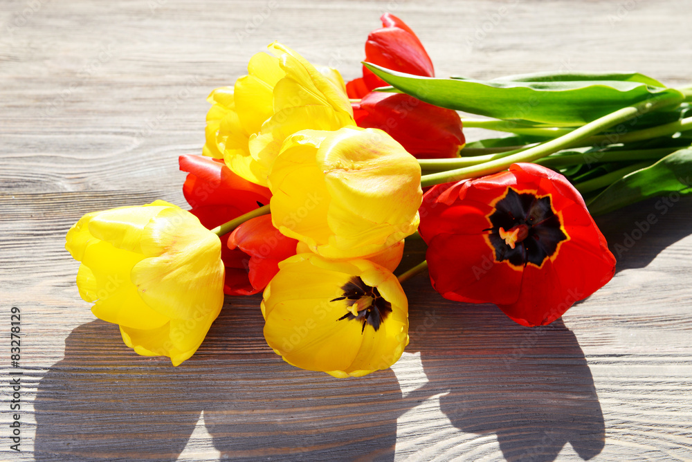 Beautiful colorful tulips on wooden table, closeup