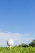 Golf ball on a tee with  sky background