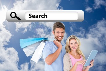 Fototapete - Couple holding shopping bags using tablet pc