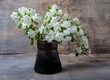 Bouquet Of White Flowers In A Metal Vase On  Wooden Background