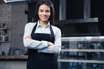 Wall Mural - Happy charming female waiter in apron