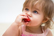 Portrait of a beautiful little girl with strawberry