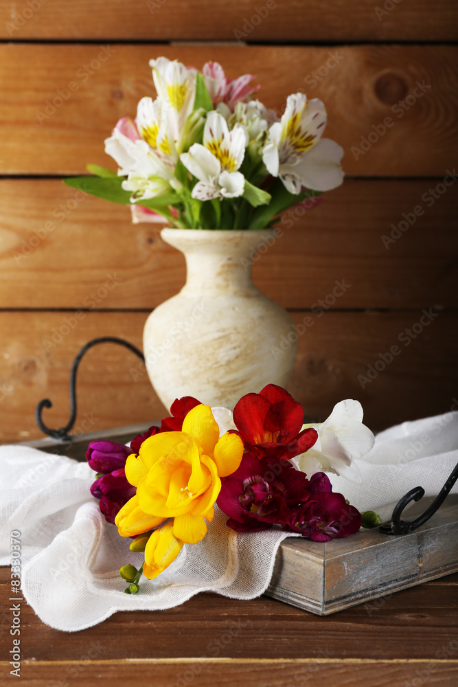 Beautiful spring flowers on wooden background