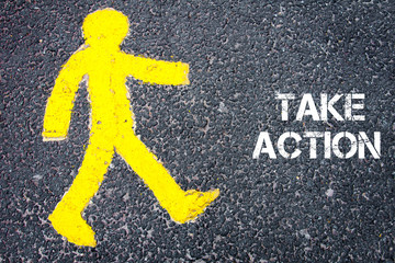 Wall Mural - Yellow pedestrian figure walking towards TAKE ACTION