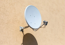 Satellite Dish Mounted On The Wall Of House