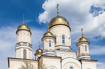 Poster - Golden domes of Russian orthodox church with cross against blue