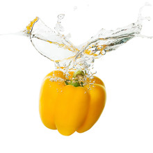 Yellow Pepper Falling In Water On The White Background