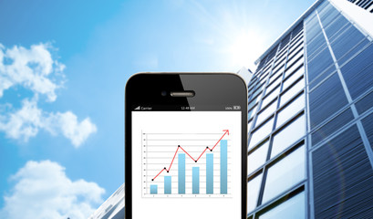 Poster - close up smart phone against business building with blue sky bac