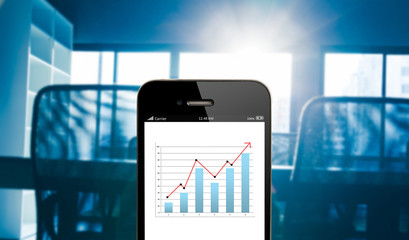 Poster - Closeup hand holding mobile phone with analyzing graph