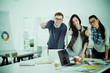 © lenets_tan - Young business people standing at office near desk and showing