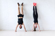 © undrey - sportsmen woman and man doing a handstand against wall concept