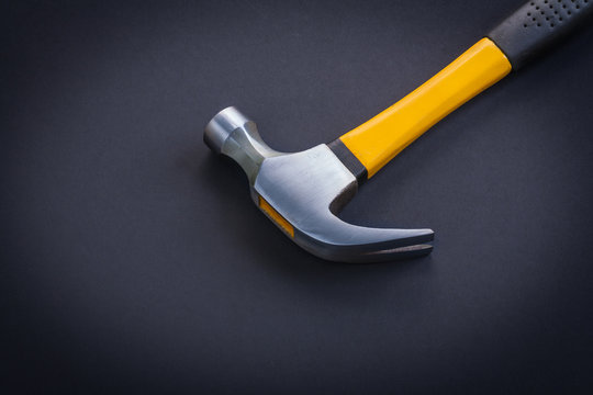 horizontal view very close up view claw hammer with yellow and r