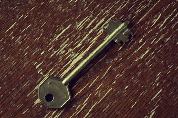 Key on the old textured wooden surface