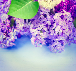 Sticker - Lilac flowers bunch over blue wooden background