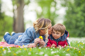 young mother kissing her cute little son