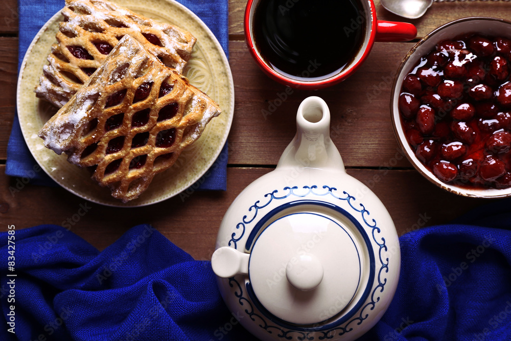 Baking, tea and jam on wooden table top view