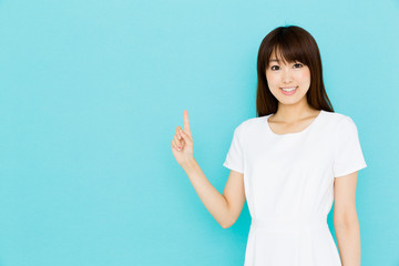 Wall Mural - attractive asian nurse on blue background