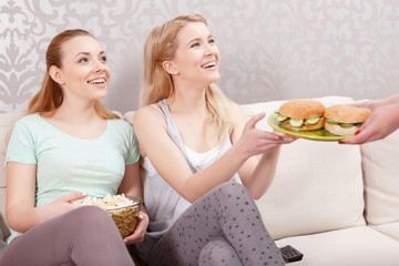 Wall Mural - Young girls having lunch at pajama party