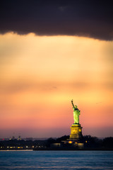  Statue of Liberty under a dramatic sunset light