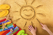 Summer Beach Smiling Sun Happy Smiley Face Drawing Drawn In Sand With Accessories Holiday Vacation Photo