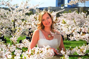 Beautiful female posing in the sakura garden