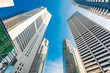 © themorningglory - Modern glass city buildings during sunny day.
